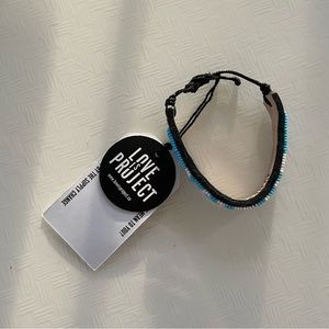 NWT amour beaded bracelet with bag and sticker